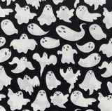 A close up of the ghosts fabric. It is a plain black background with white ghosts all over.