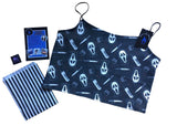 The ghostface crop top laid out flat to show the details and shape of the top. It has elasticated shoulder straps. The image shows the black and white striped packaging the top comes in with the leaflet and stickers.