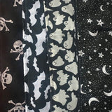 An image showing the various scarf patterns available including skull and crossbones, pentagrams, bats and ghosts. The design this listing would purchase is the bats, this is a black background with white bats silhouettes.