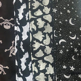 An image showing the various scarf patterns available including skull and crossbones, pentagrams, bats and ghosts. The design this listing would purchase is the pentagrams and moons, this is a black background with white pentagrams and moons.