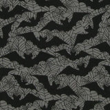 Close up of the fabric. A grey background with black spiderweb outlines and black bat silhouettes. This is a poly cotton mix fabric with vibrant and pigmented colour.