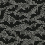 Close up of the fabric. A grey background with black spiderweb outlines and black bat silhouettes. This is a poly cotton mix fabric with vibrant and pigmented colour.