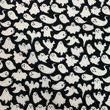 A close up of the fabric, a black block background with white ghosts all over.