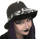 A summer goth hat with a black and white bat fabric. A reversible design with two wearing options. Suitable for a goth summer party, a goth beach hat, or a goth Easter party. The fabric is black and white bats in various sizes flying around.