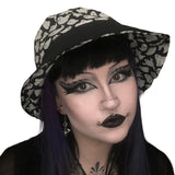 A summer goth hat with a black and white ghost fabric. A reversible design with two wearing options. Suitable for a goth summer party, a goth beach hat, or a goth Easter party. The fabric is black and white ghosts in various sizes.