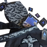 Large coffin shape shoulder bag with cross on the frontside and a velvet transfer outline. The shoulder straps are hemmed with black lace. As a gift set it comes with a smaller zip up coffin cosmetics bag in matching fabrics. With leaflets + stickers