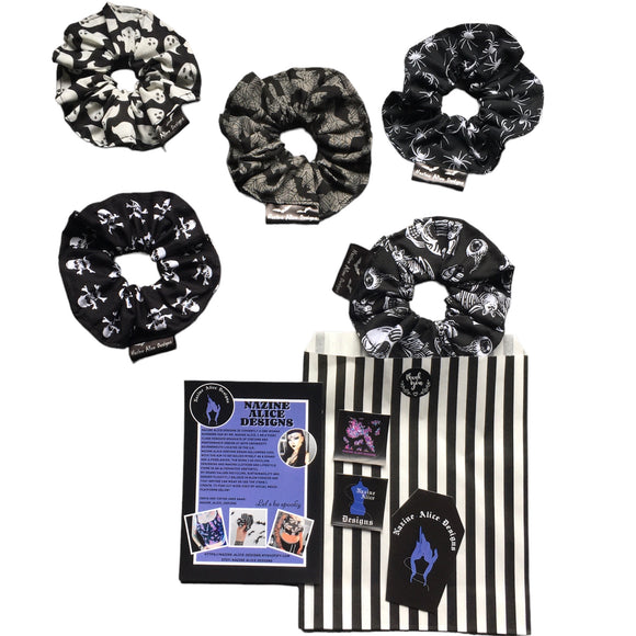 A gift set of gothic hair scrunchies in different goth fabrics. A set of 5 goth scrunchie gift set includes one in each fabric, this includes: trick or treat, grey bats and webs, skull and crossbones, ghosts and spiders. All fabrics are monochrome. It comes with gift packaging and branded labels and stickers.