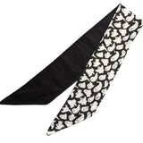 Lightweight cotton fabric scarf folded once to show front and back side. The front side fabric is an alternative gothic styled print of black background and white ghosts, and the back side fabric is black. The edges are neatly hemmed.