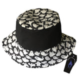 A summer goth hat with a black and white ghost fabric. A reversible design with two wearing options. Suitable for a goth summer party, a goth beach hat, or a goth Easter party. The fabric is black and white ghosts in various sizes.