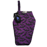 Coffin shaped makeup bag made with gothic fabric. It is a purple background with black lines of spiderwebs and black shiloettes of flying bats. The coffin shape cosmetics bag has a Nazine Alice Designs logo tag and a hook loop in the top left corner.