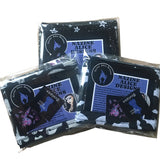 3 different lightweight goth scarves folded neatly in recyclable clear packaging bags showing how they'll be received in the post with branded leaflet and stickers included. Theb fabrics shown include the witchy pentagrams and moons, bats and ghosts.