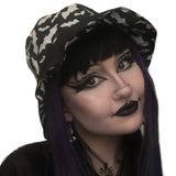 A summer goth hat with a black and white bat fabric. A reversible design with two wearing options. Suitable for a goth summer party, a goth beach hat, or a goth Easter party. The fabric is black and white bats in various sizes flying around.